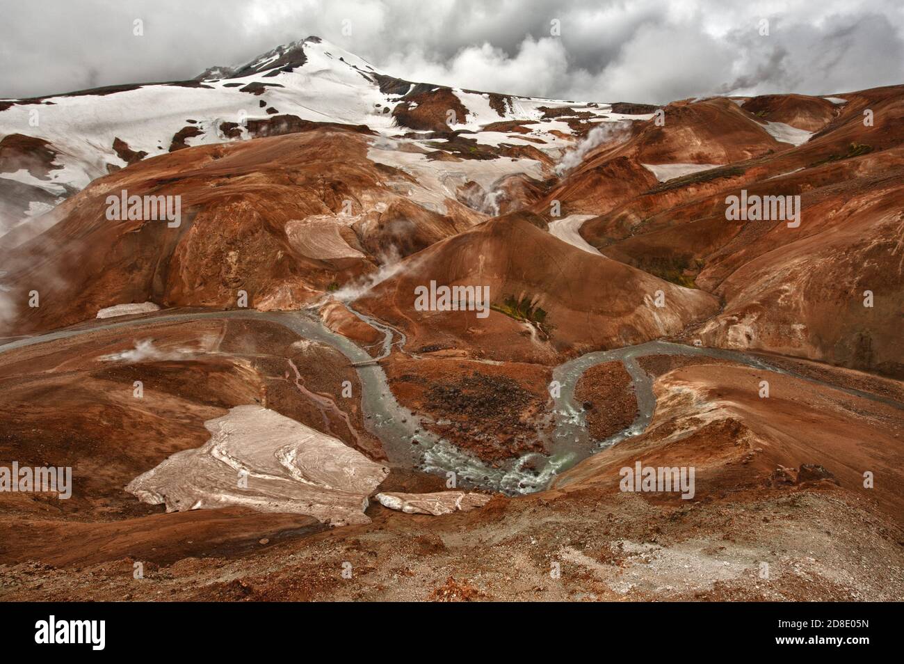 Iceland is a land of ice and fire. In the geothermal area Kerlingarfjoll one can see smoke and boiling fumaroles from the geothermal field as well as Stock Photo