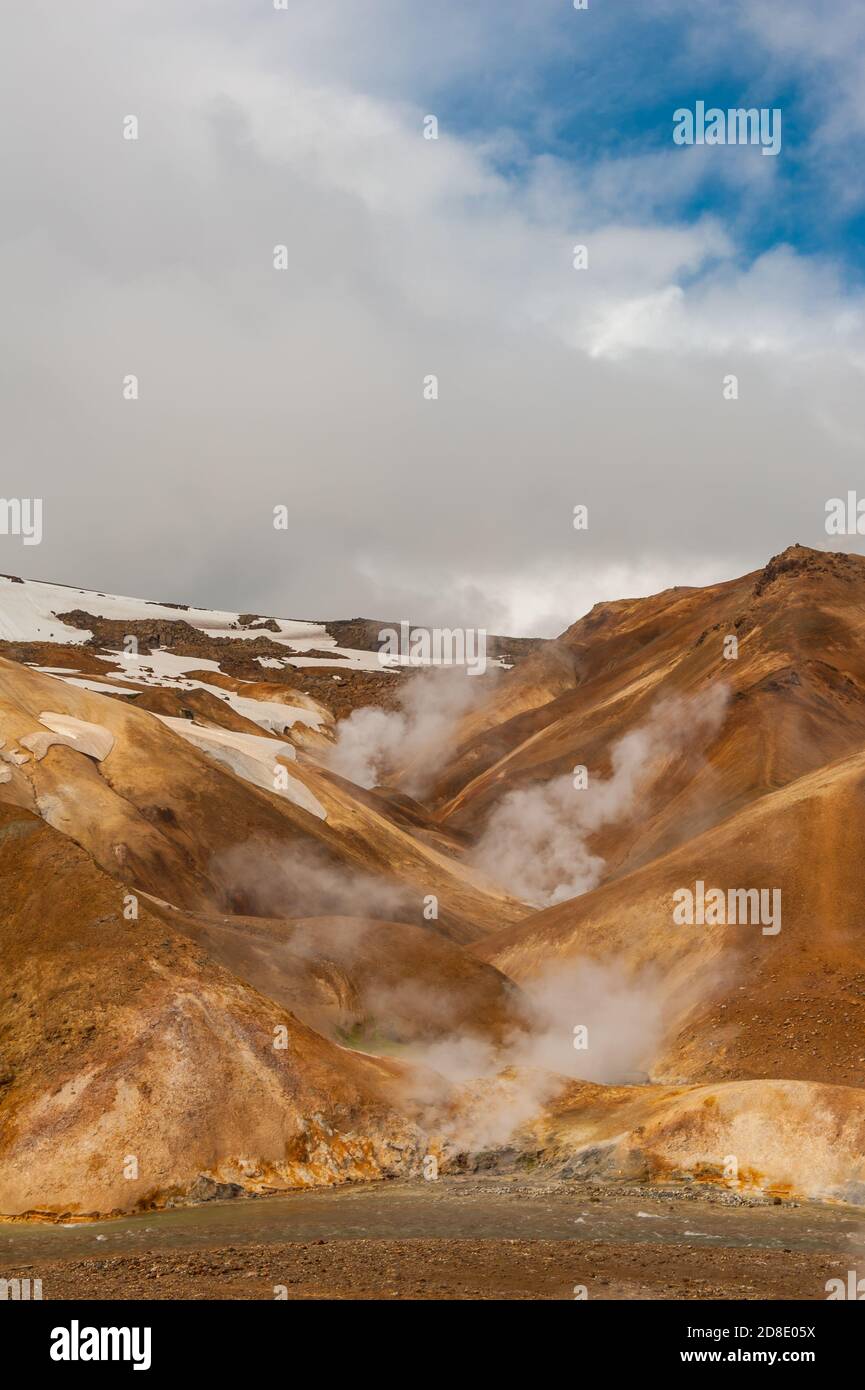 Iceland is a land of ice and fire. In the geothermal area Kerlingarfjoll one can see smoke and boiling fumaroles from the geothermal field as well as Stock Photo