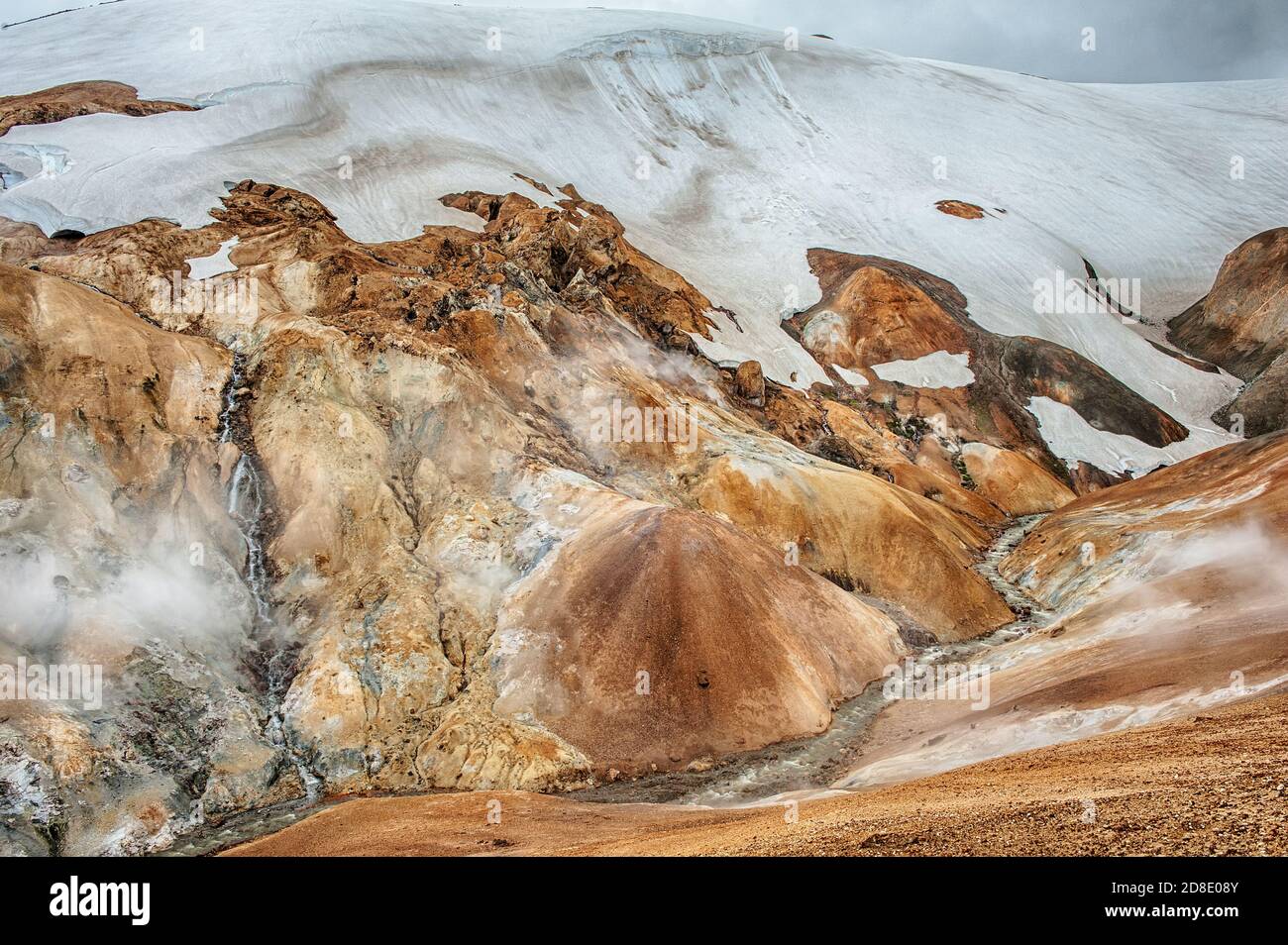 Iceland is a land of ice and fire. In the geothermal area Kerlingarfjoll one can see smoke and boiling fumaroles from the geothermal field as well as Stock Photo