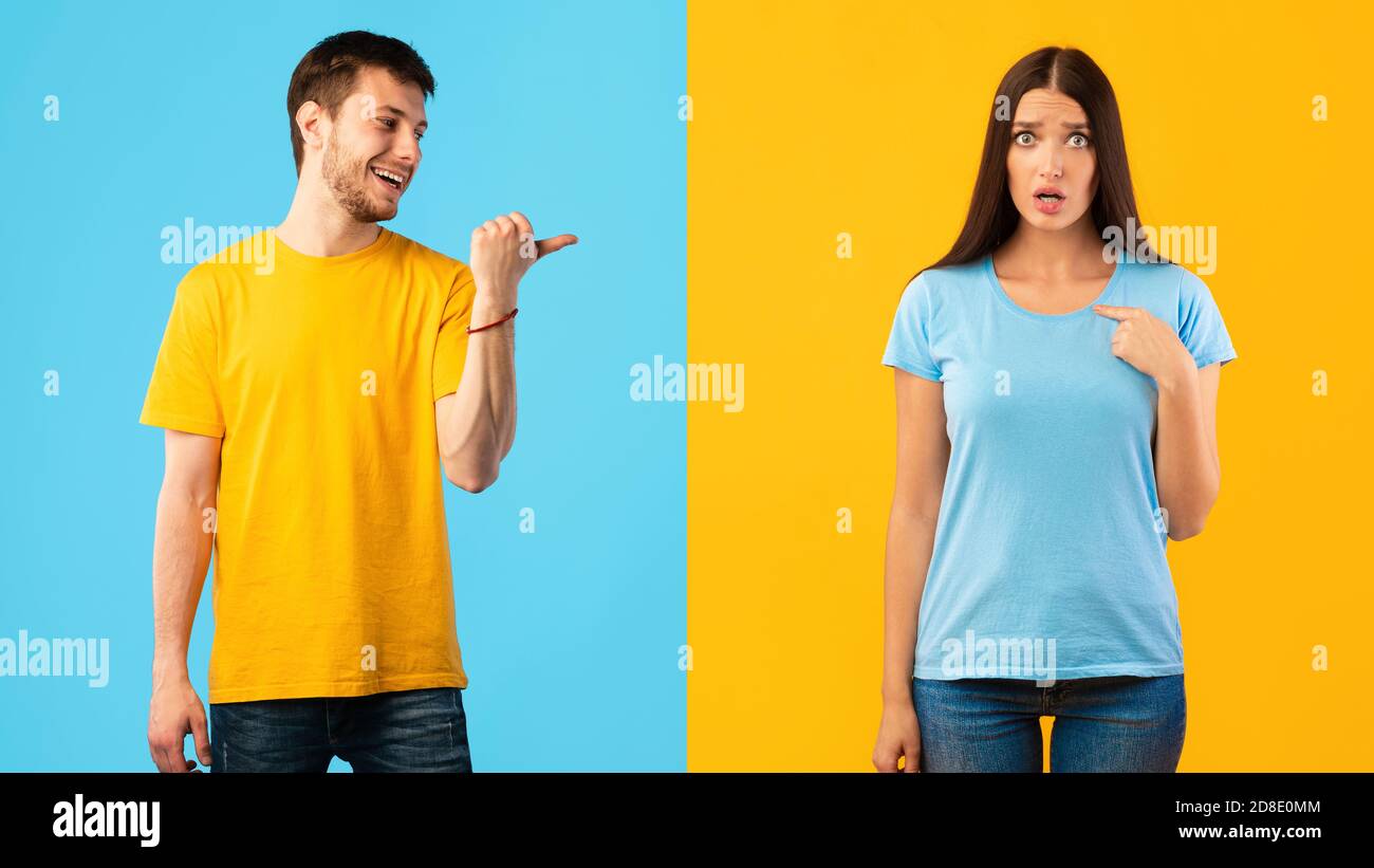 Woman pointing finger at herself, man indicating her Stock Photo - Alamy