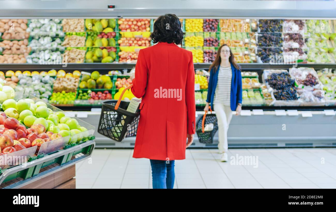 Grocery clerk working in produce aisle of supermarket store Stock Photo by  ©FreeProd 118794062