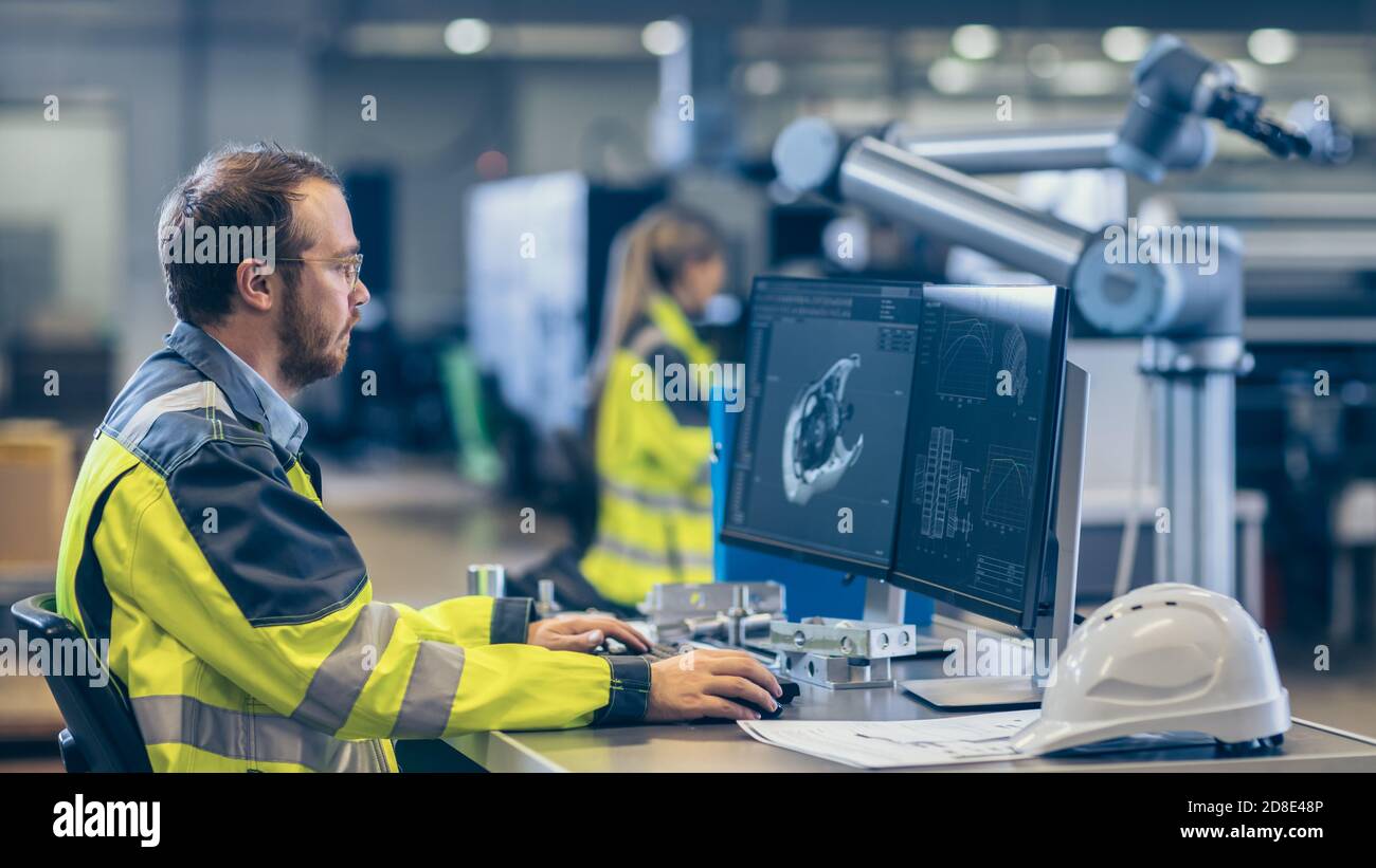 At the Factory Mechanical Engineer Works on Computer, Designs in CAD