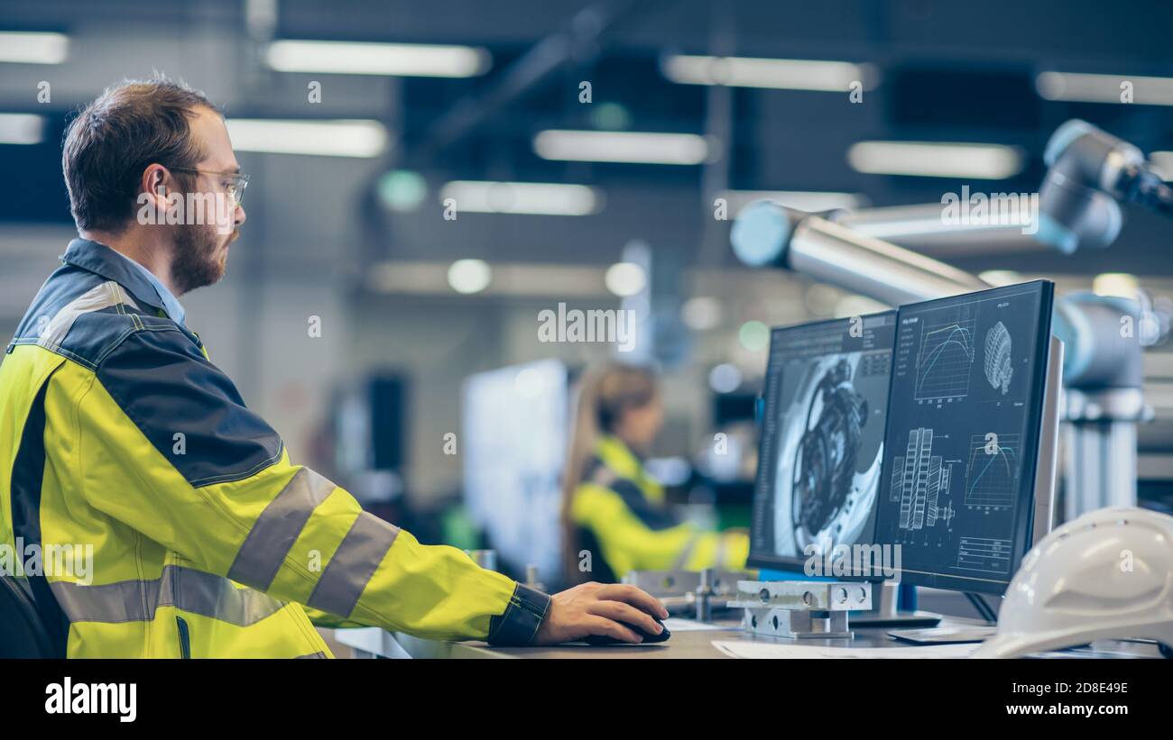 At the Factory Mechanical Engineer Works on Computer, Designs in CAD