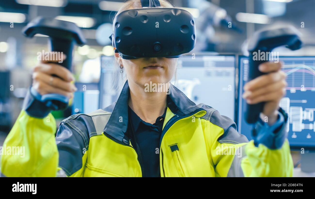 Portrait Female Mechanical Engineer Wearing Virtual Reality Headset and Using Controllers, She Uses VR technology for Industrial Design, Development Stock Photo