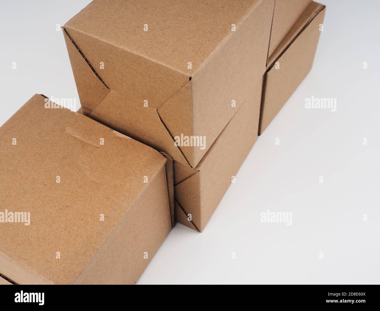 several cardboard boxes. Cardboard Boxes Stacked Against White Background. Stock Photo