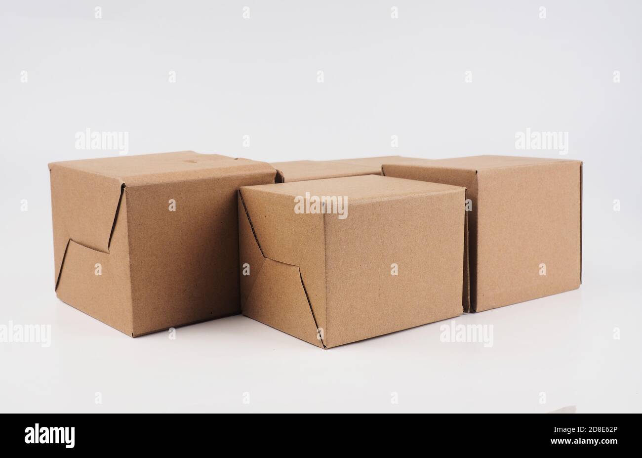 several cardboard boxes. Cardboard Boxes Stacked Against White Background. Stock Photo
