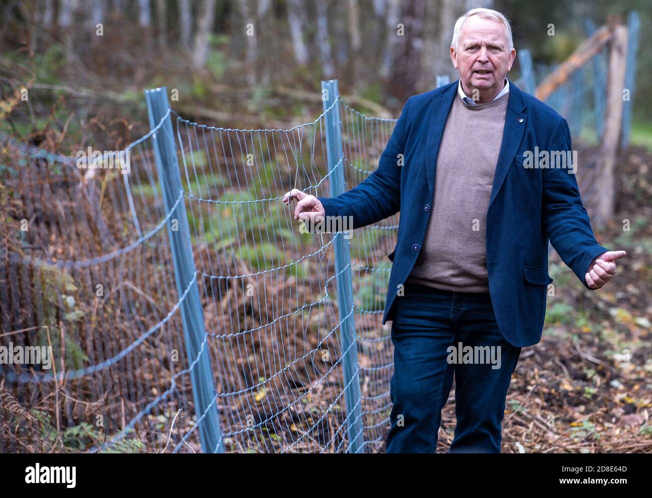 22 October 2020, Mecklenburg-Western Pomerania, Korswandt: Till Backhaus (SPD), the Minister of Agriculture of Mecklenburg-Vorpommern, is standing at the border between Poland and Germany at the new protective fence to guard against swine fever. A metal fence is to prevent the overflow of wild boars in case African swine fever (ASP) spreads along the coast. The wild boar fence for protection against swine fever at the border to Poland is halfway finished in Mecklenburg-Western Pomerania. To prevent the introduction of the animal disease, which is widespread in Poland, the state is erecting the Stock Photo