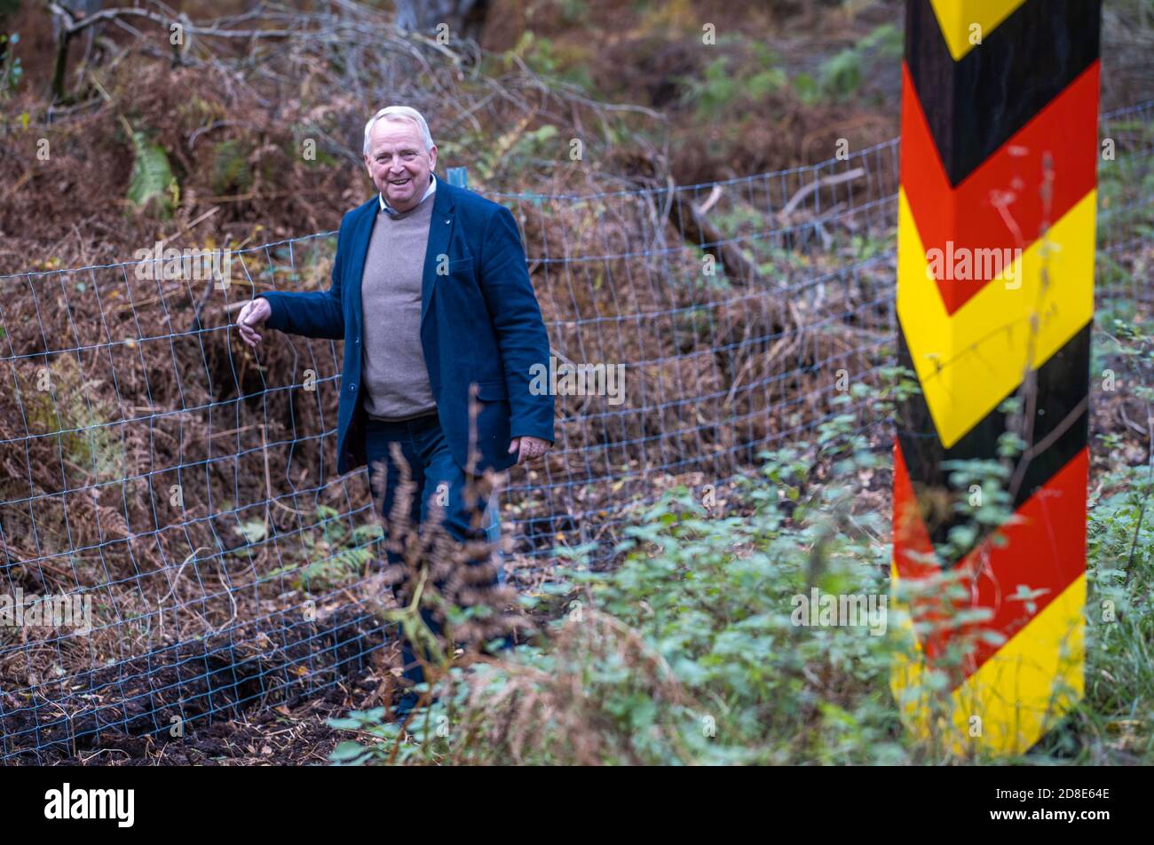22 October 2020, Mecklenburg-Western Pomerania, Korswandt: Till Backhaus (SPD), the Minister of Agriculture of Mecklenburg-Vorpommern, is standing at the border between Poland and Germany at the new protective fence to guard against swine fever. A metal fence is to prevent the overflow of wild boars in case African swine fever (ASP) spreads along the coast. The wild boar fence to protect against swine fever at the border to Poland is halfway finished in Mecklenburg-Western Pomerania. To prevent the introduction of the animal disease, which is widespread in Poland, the state is erecting the 62. Stock Photo