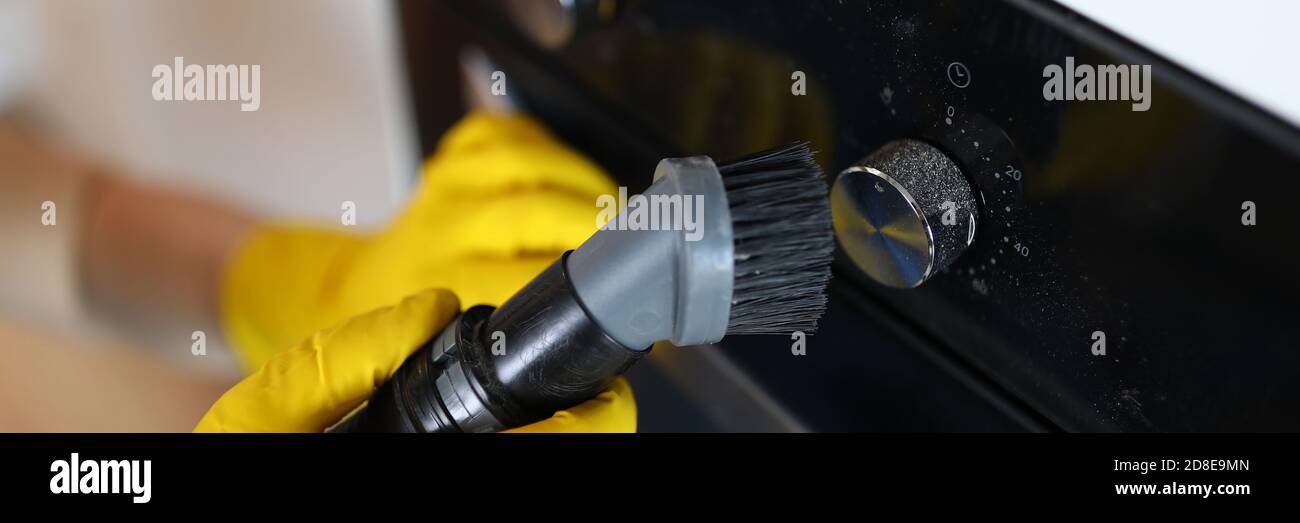 Worker dusting stove Stock Photo Alamy