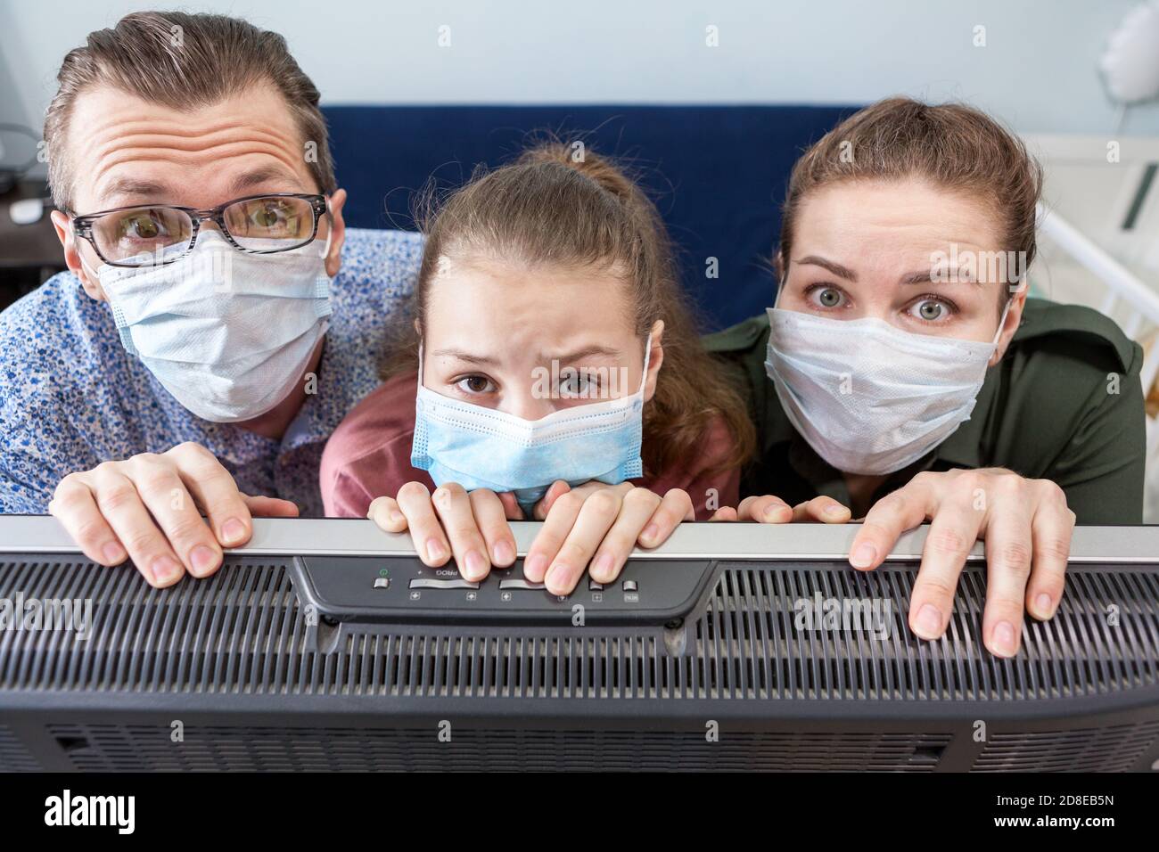 Caucasian father, mother and teenage girl wearing medical masks
