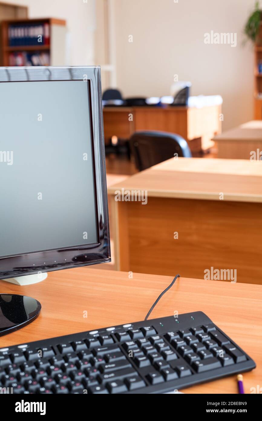 Out of work business office with turned off computers, empty workplaces, nobody Stock Photo
