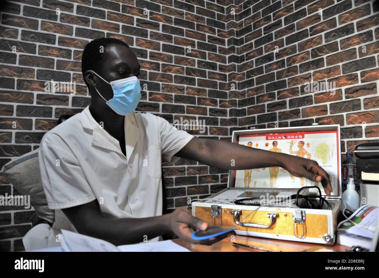 Accra, Ghana. 22nd Oct, 2020. A Ghanaian doctor treats a patient with