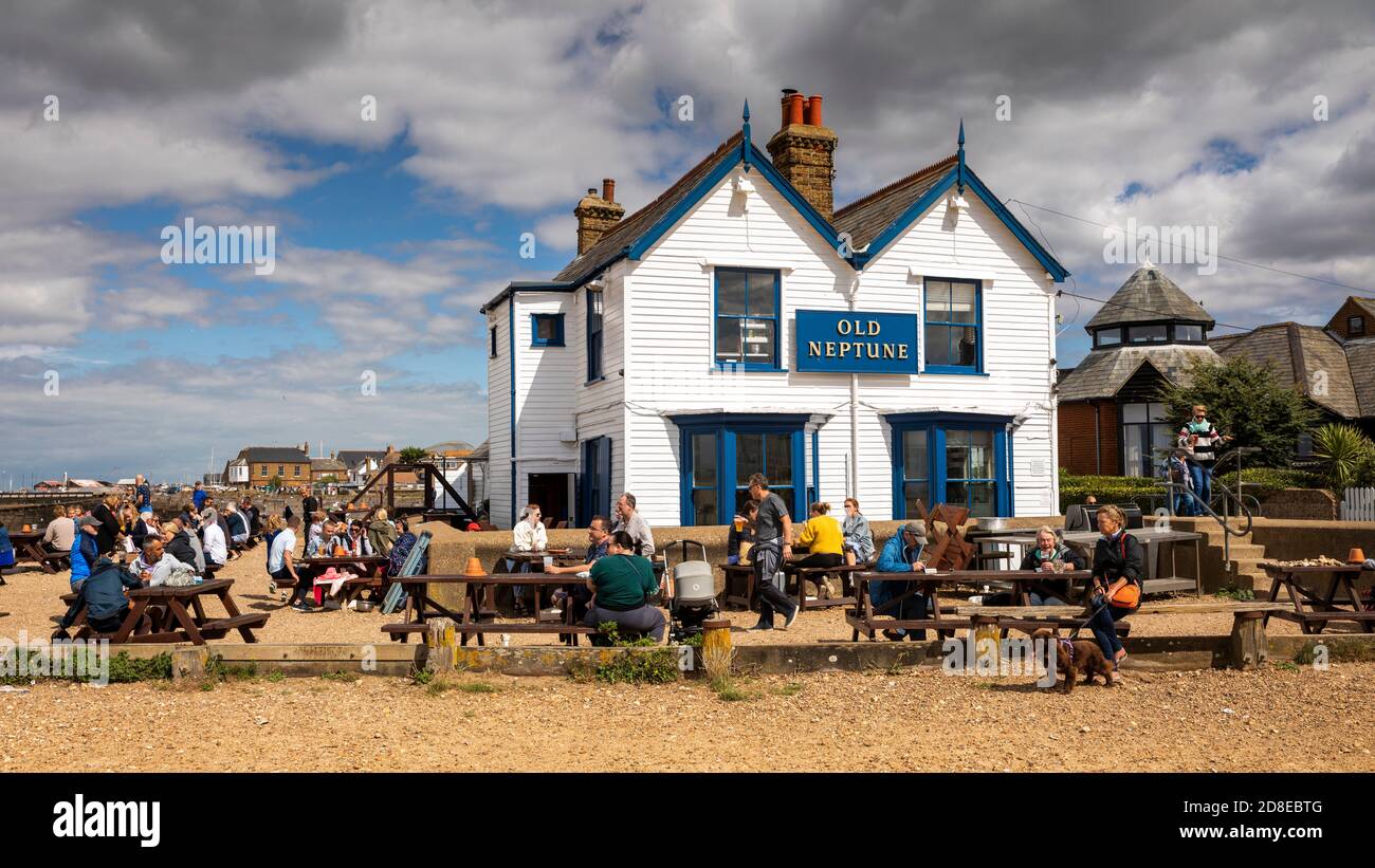 UK, Kent, Whitstable, Shipwrights Lee, customers on beach tables outside Old Neptune Inn, panoramic Stock Photo