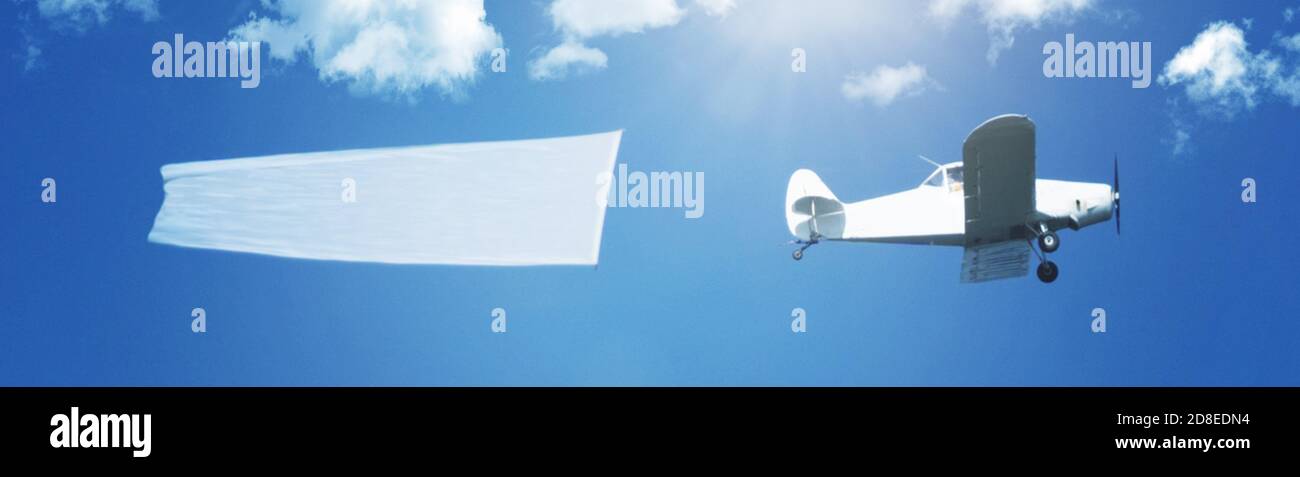 String Airplane Flying airplane aircraft with string pulling and a white copy space ...