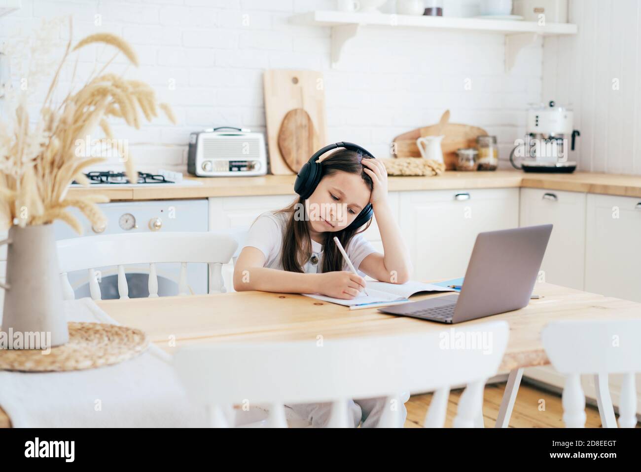 girl doing homework with headphones Stock Photo Alamy