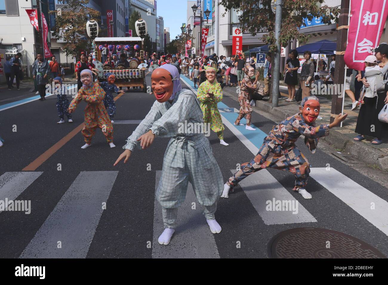 Children in traditional Japanese costume with masks dance at autumn festival in Kawagoe city near Tokyo Stock Photo