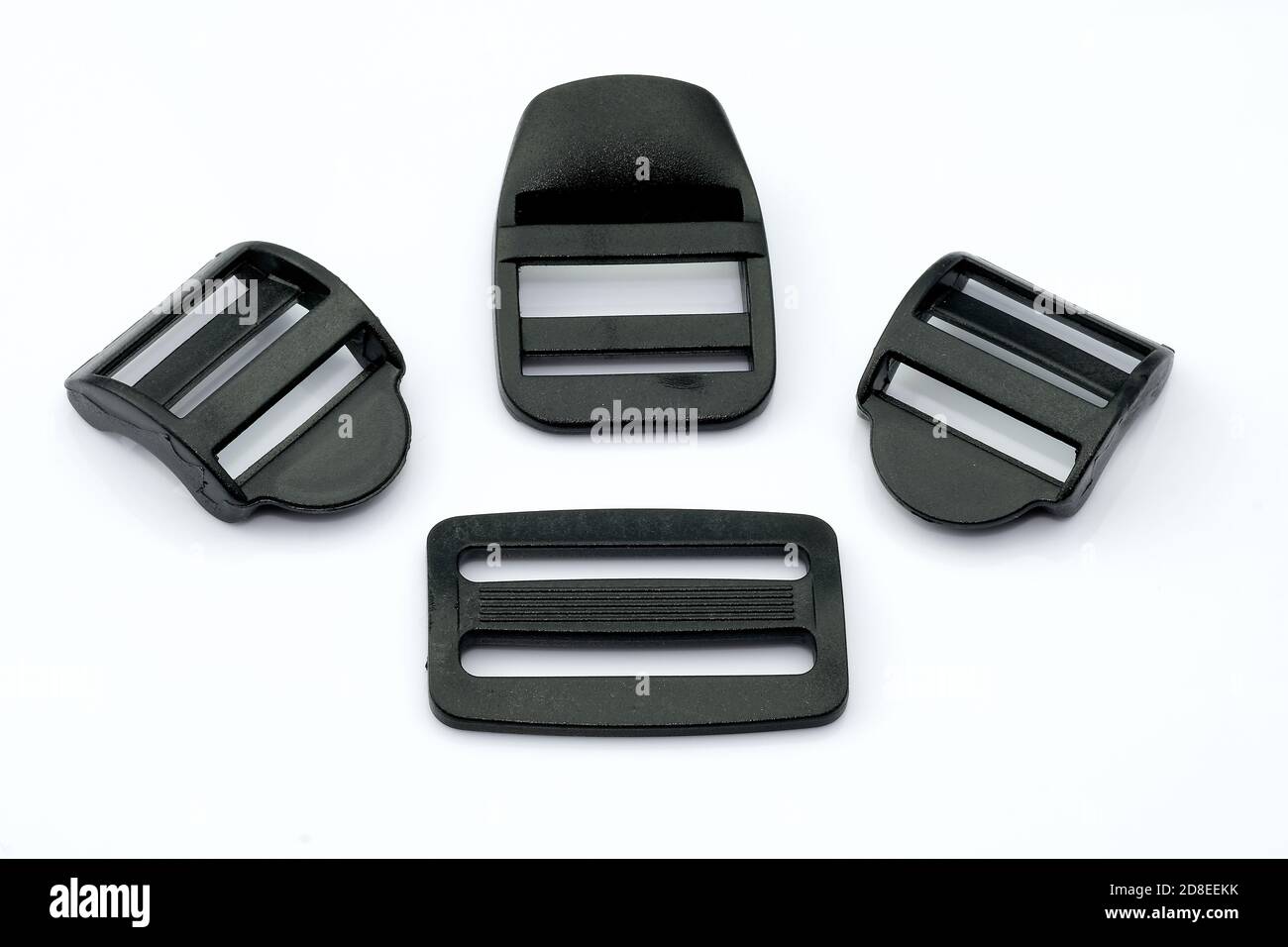 Black plastic buckles for a belt on a white background. Plastic straps