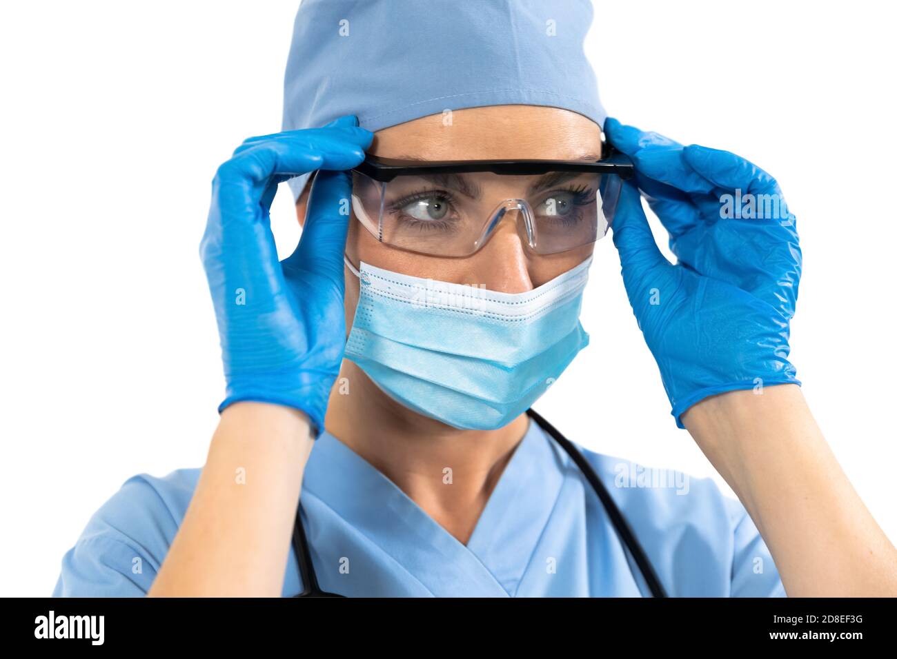 Female surgeon wearing protective glasses against white background
