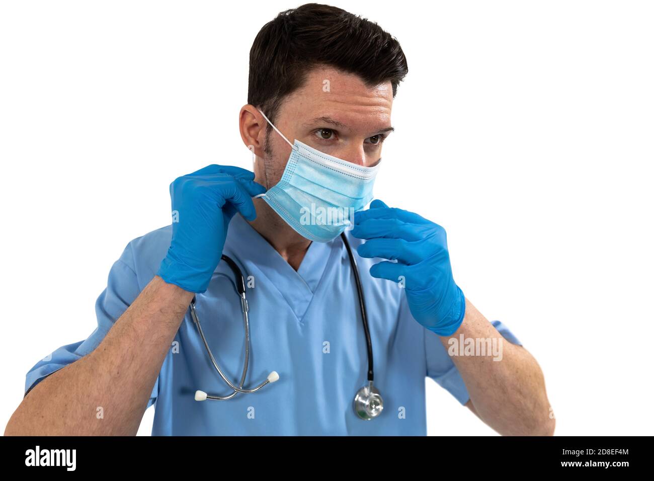 Male surgeon wearing face mask against white background Stock Photo - Alamy
