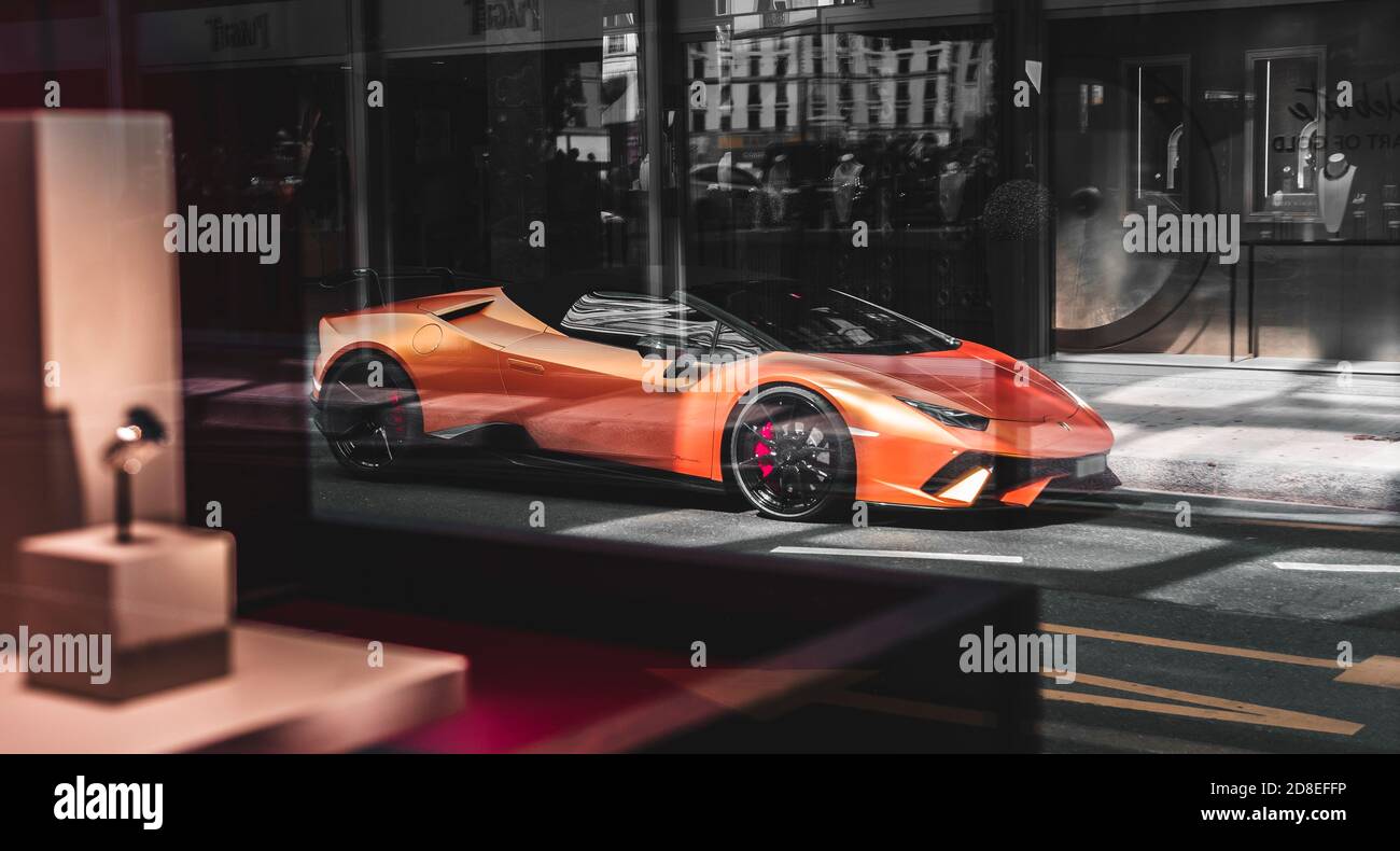 Lamborghini Huracan Spyder seen through a glass in which stands a beautiful and luxurious ring, Geneva, Switzerland. Stock Photo