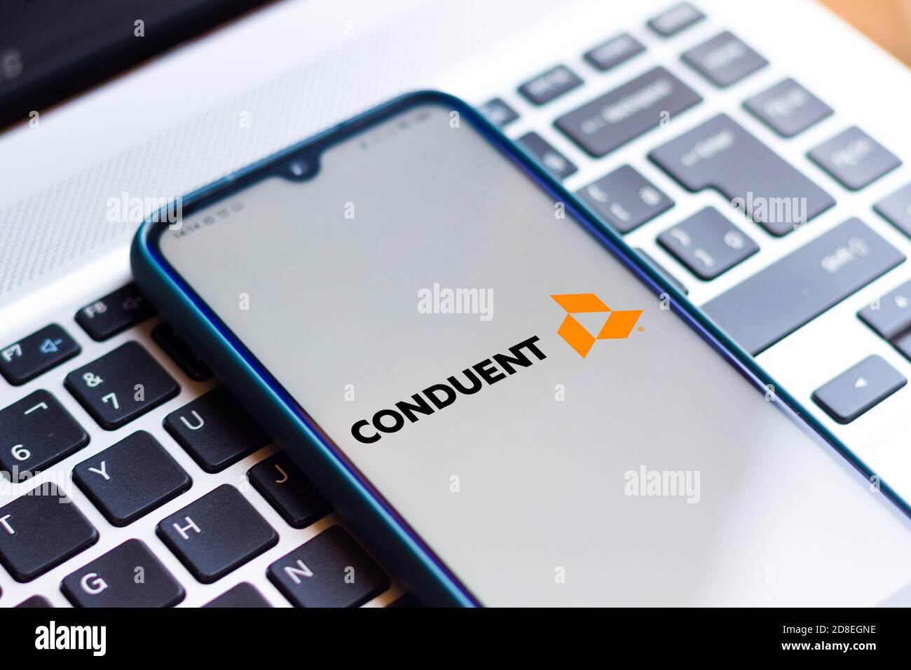 In this photo illustration the Conduent logo seen displayed on a