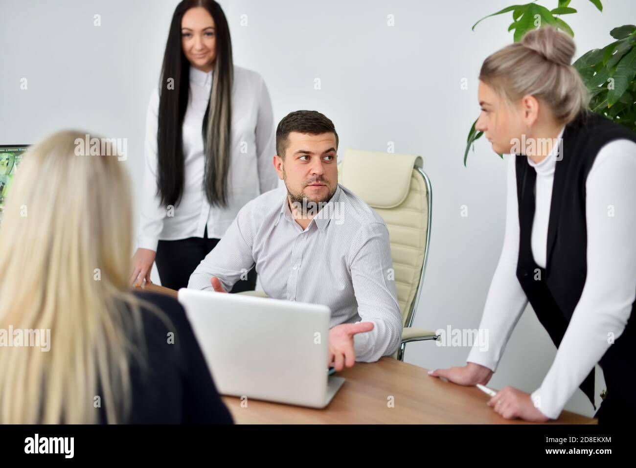 Meeting of female employees and young CEO in office Stock Photo