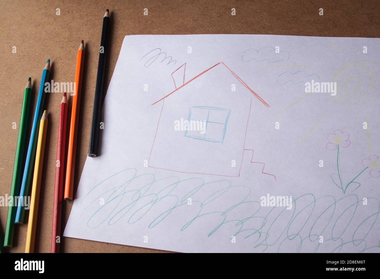 Kids drawing of family and colored pencils on wooden table Stock Photo -  Alamy