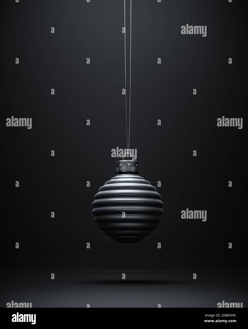 Illuminated horizontal striped bauble against dark grey shaded background. Black and white view of Christmas ball. Christmas decoration, festive atmos Stock Photo