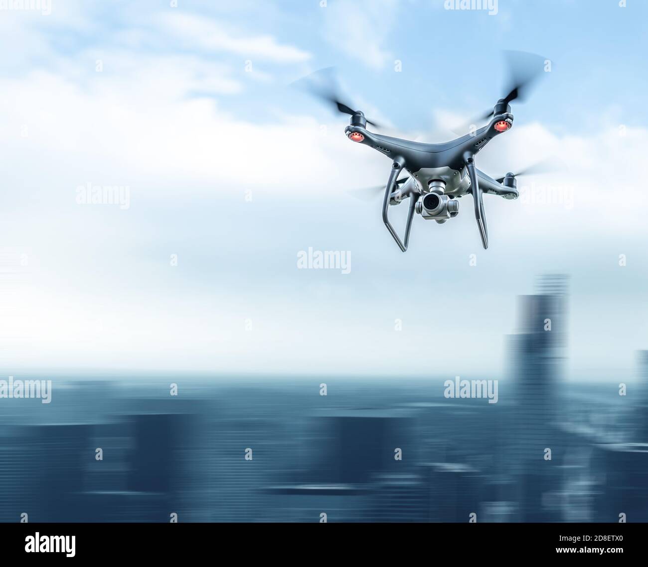 A modern drone in the sky over a large city. Stock Photo