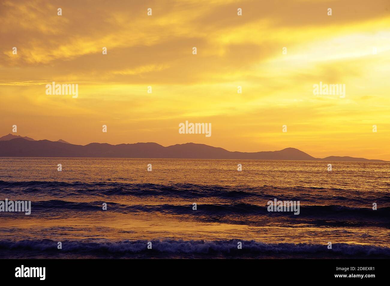 sunny sea during sunset with some clouds Stock Photo - Alamy