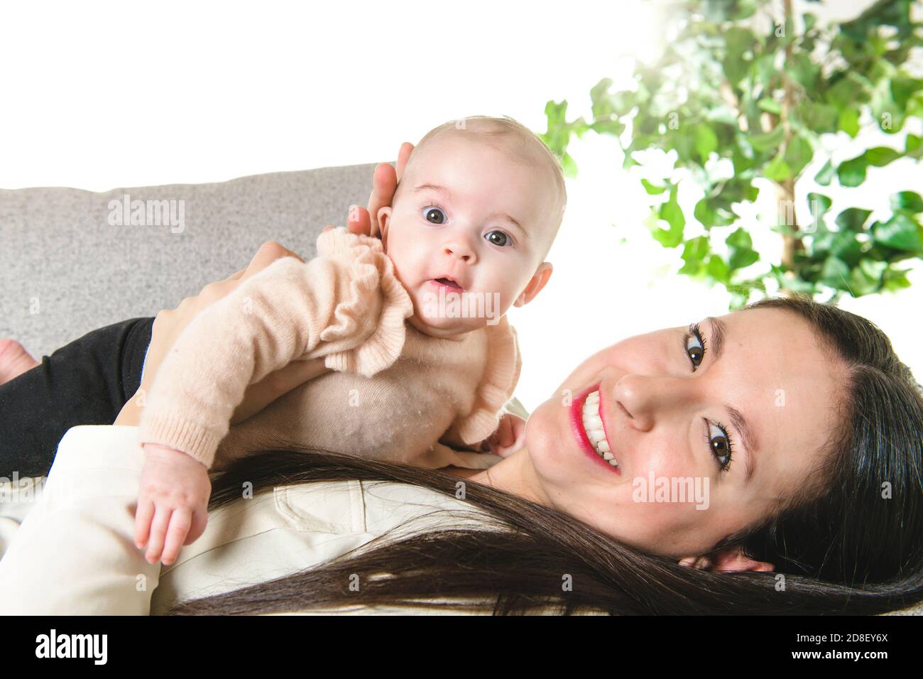 A nice Mother with baby girl on the sofa Stock Photo