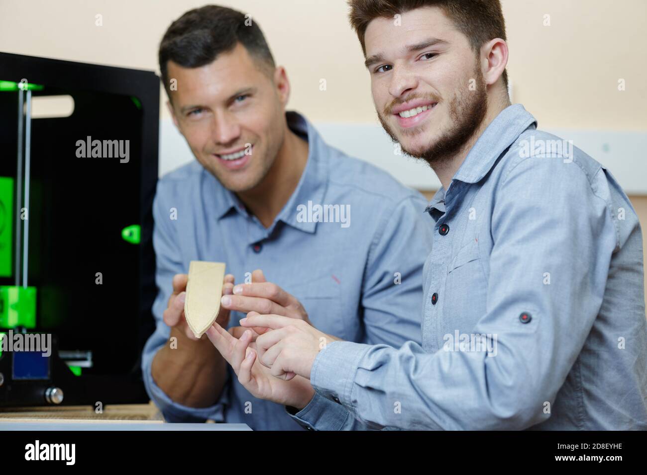 workers showing product created by 3d printer Stock Photo