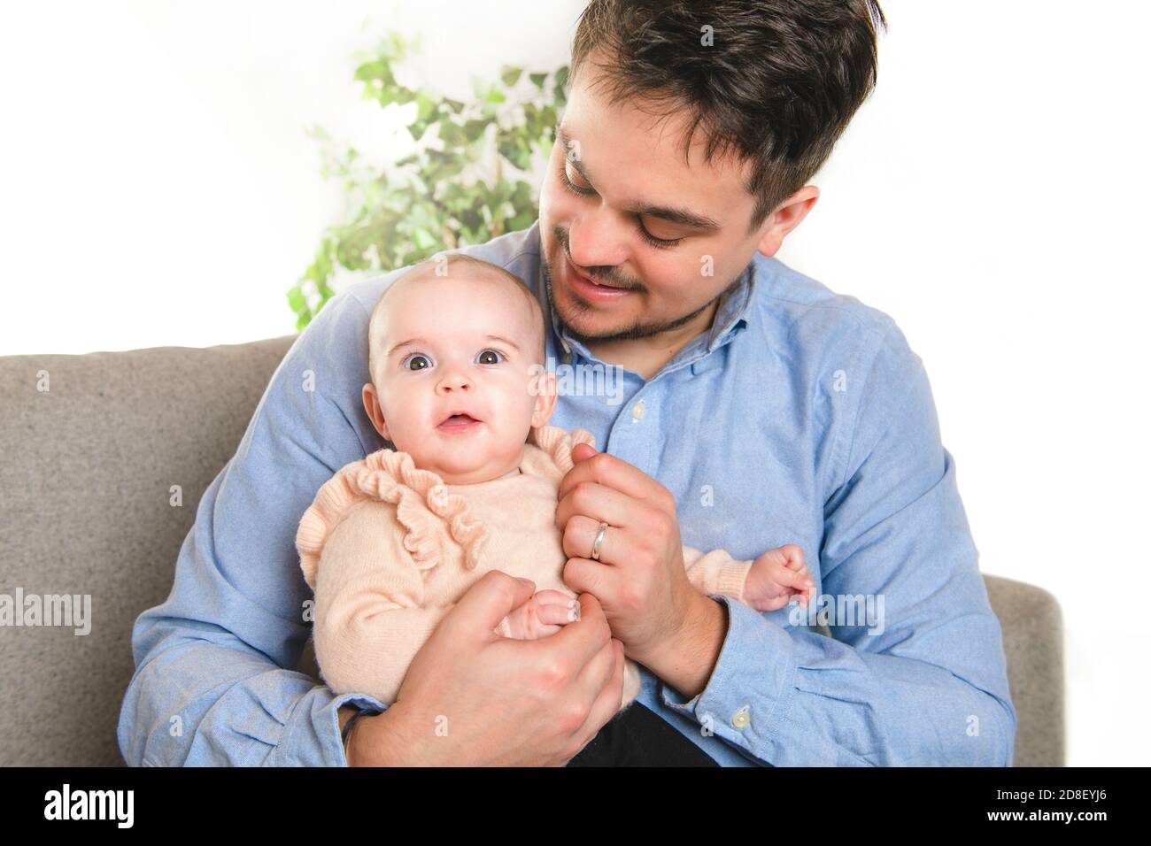 A nice father with baby girl on the sofa Stock Photo