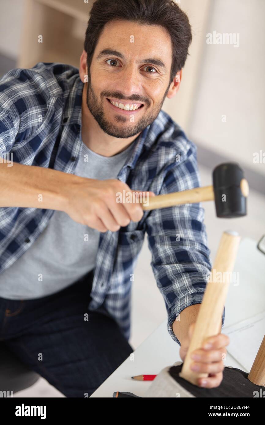 young man using repair tools to build new furniture Stock Photo Alamy