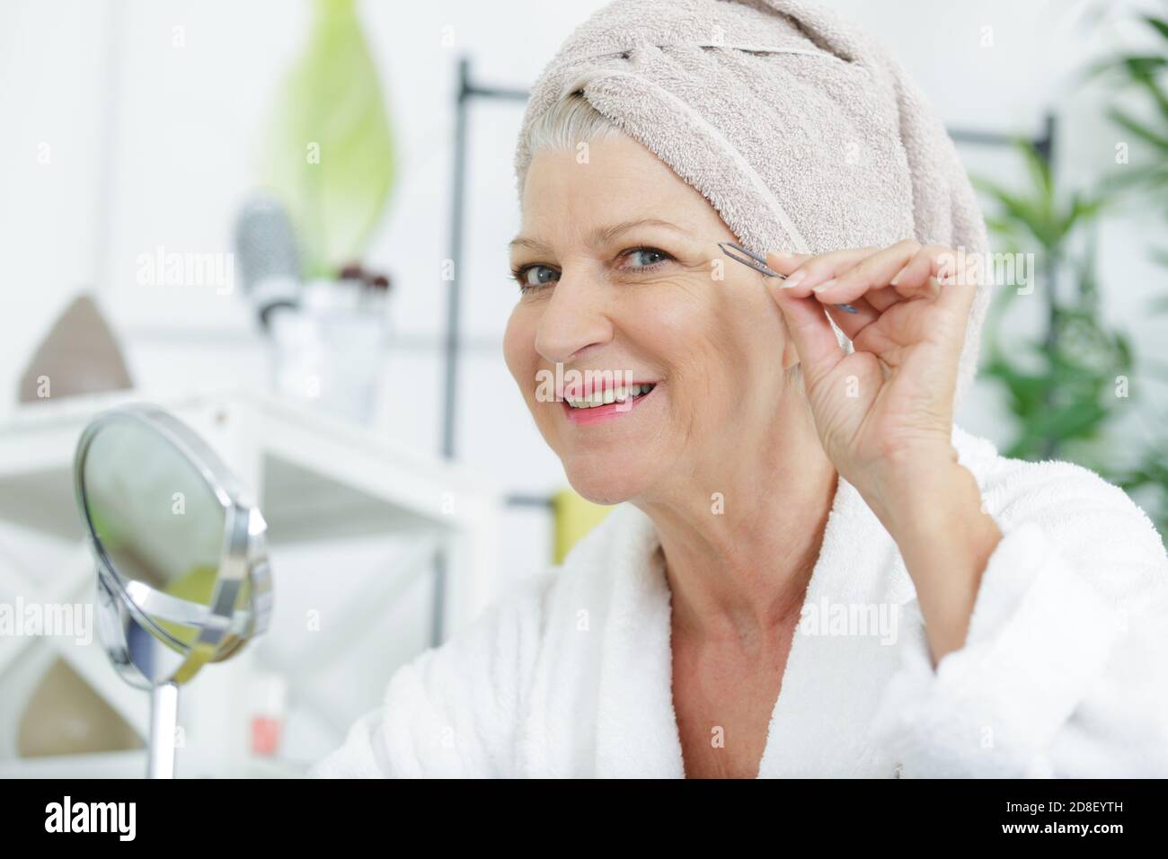 portrait of mature woman plucking facial hair Stock Photo Alamy