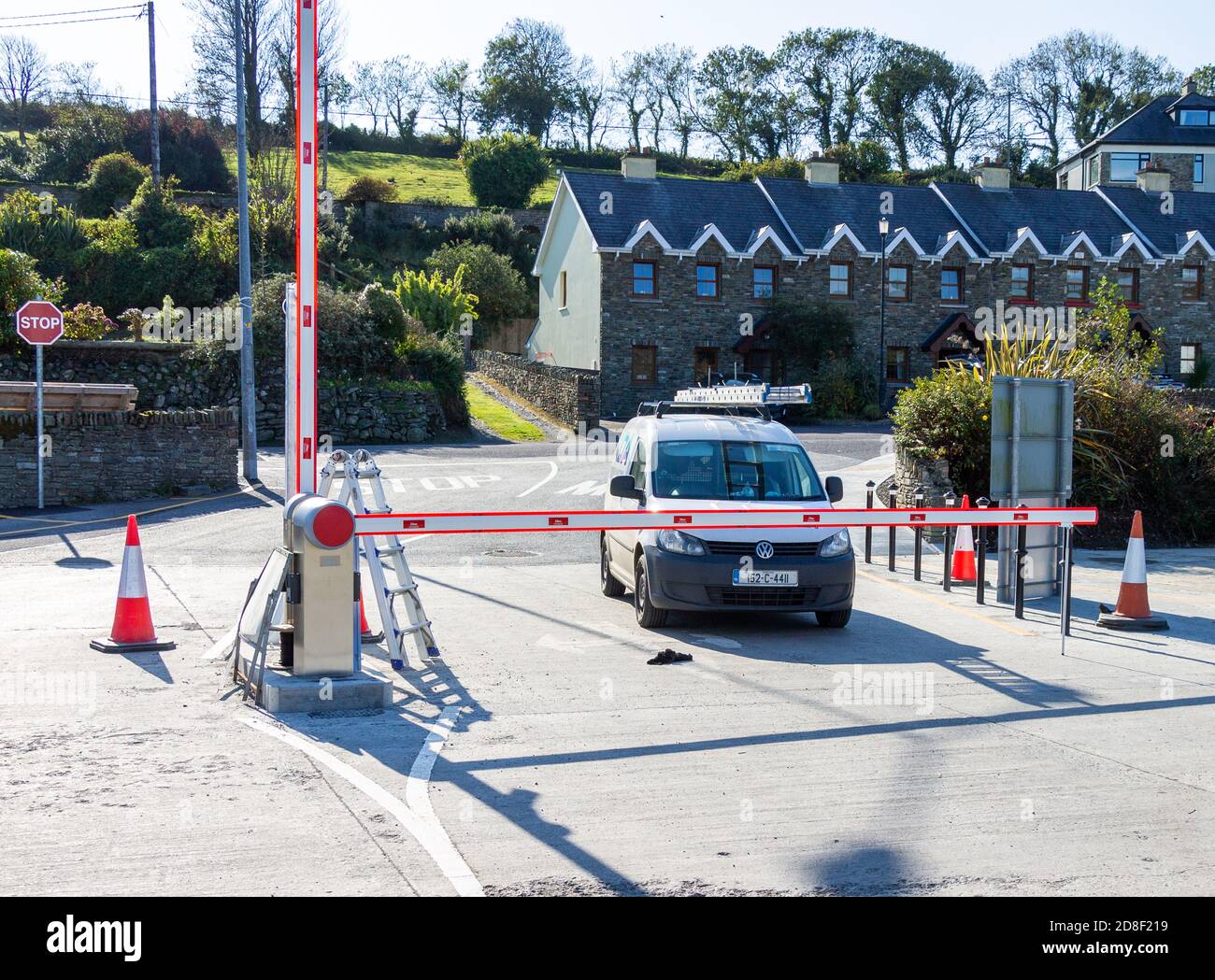 Car stopped at Automatic Barrier with Terraced Houses Stock Photo