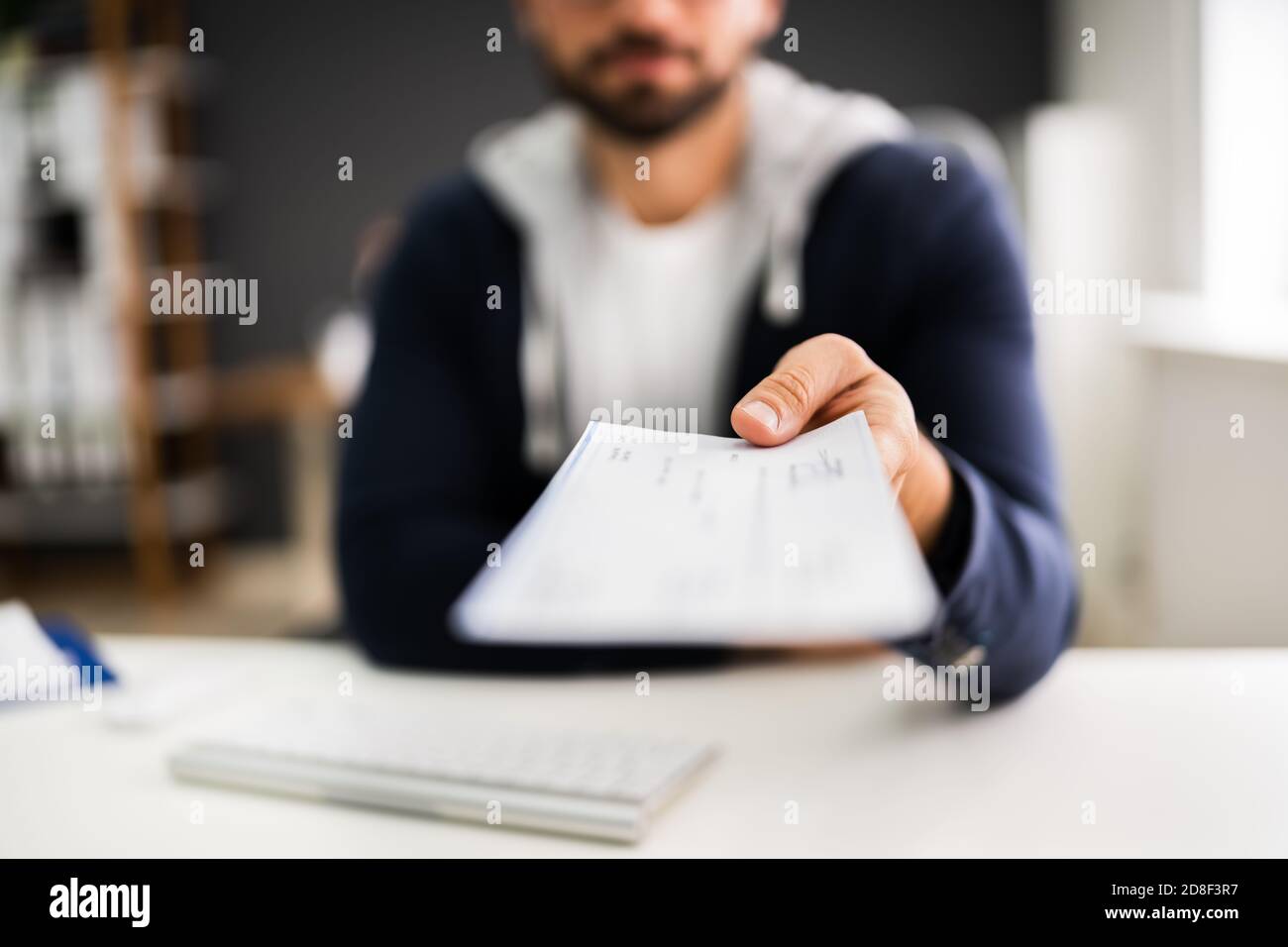 Man Giving Payroll Compensation Paycheck Or Cheque Stock Photo