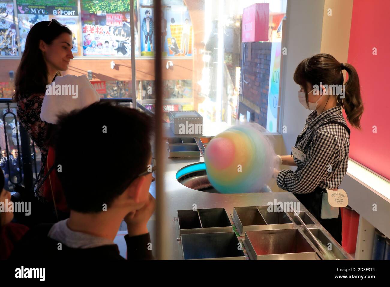 A shop worker making a colorful cotton candy in a candy shop.Takeshita Street.Harajuku.Tokyo.Japan Stock Photo