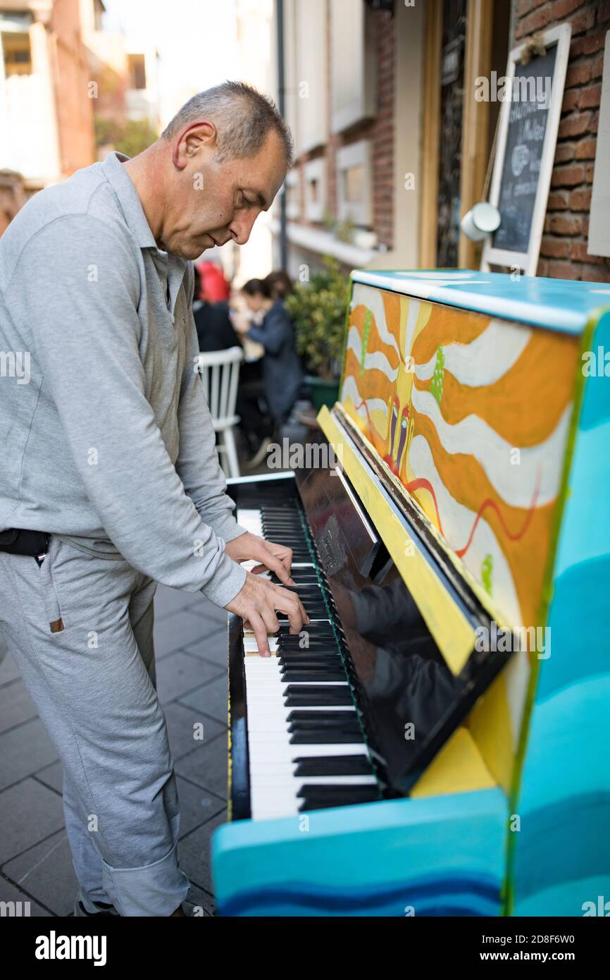A man plays piano at an open-air cafe on the streets of Tbilisi, Georgia, Caucasus, Eastern Europe. Stock Photo