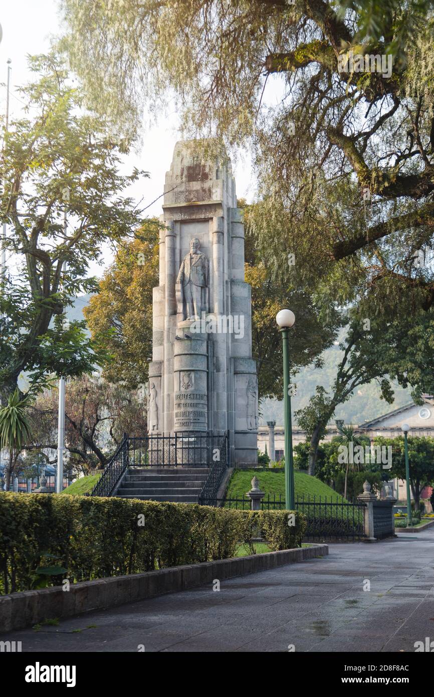 Monument to Justo Rufino Barrios in central park of Quetzaltenango Guatemala early in the morning - empty park of colonial city with mountains in the Stock Photo
