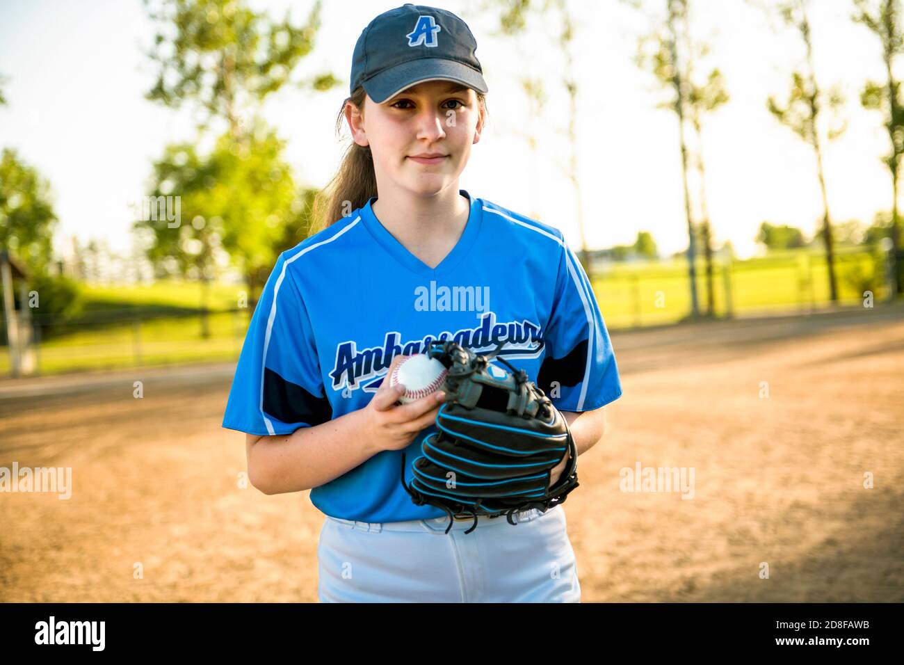 The pre-teen child girl in baseball field Stock Photo