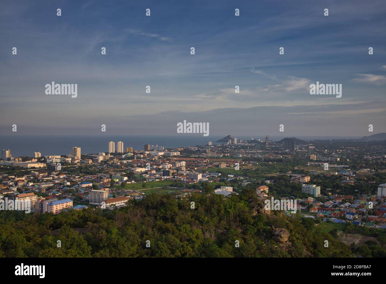 This unique photo shows the sunset in late October over the Thai seaside town called Hua Hin. you can see the houses and mountains very well. Stock Photo