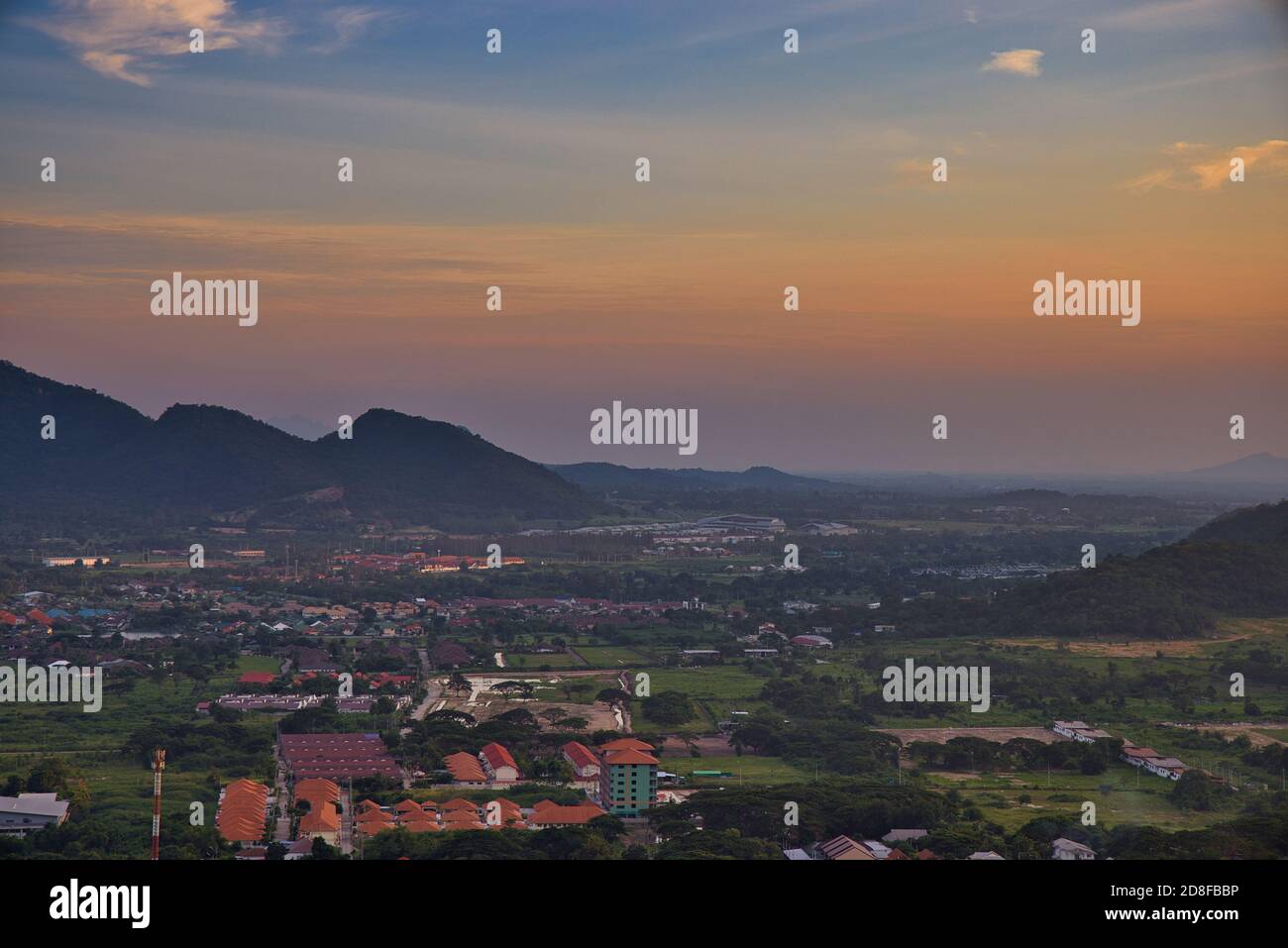 This unique photo shows the sunset in late October over the Thai seaside town called Hua Hin. you can see the houses and mountains very well. Stock Photo
