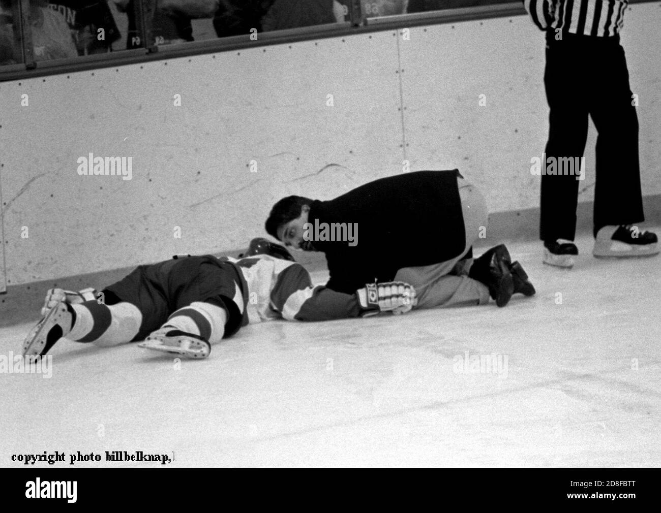 Exclusive images of Injured Boston University Hockey player Travis Roy is carried for by team doctor on the ice after after striking the boards. Roy was paralyized in the by the injury. Exclusive photo by Bill belknap Dec 16,1998 Stock Photo