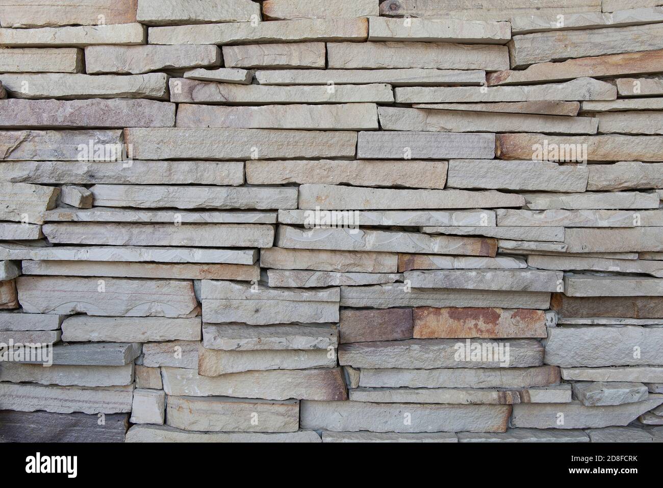 White stone cladding walls background. White sandstone cladding wall