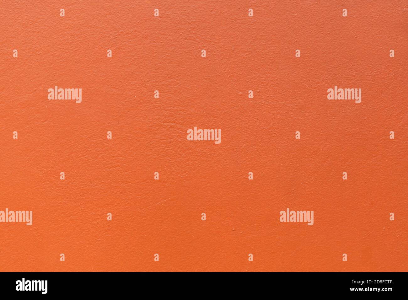 Plastered wall painted orange colour background. Stock Photo