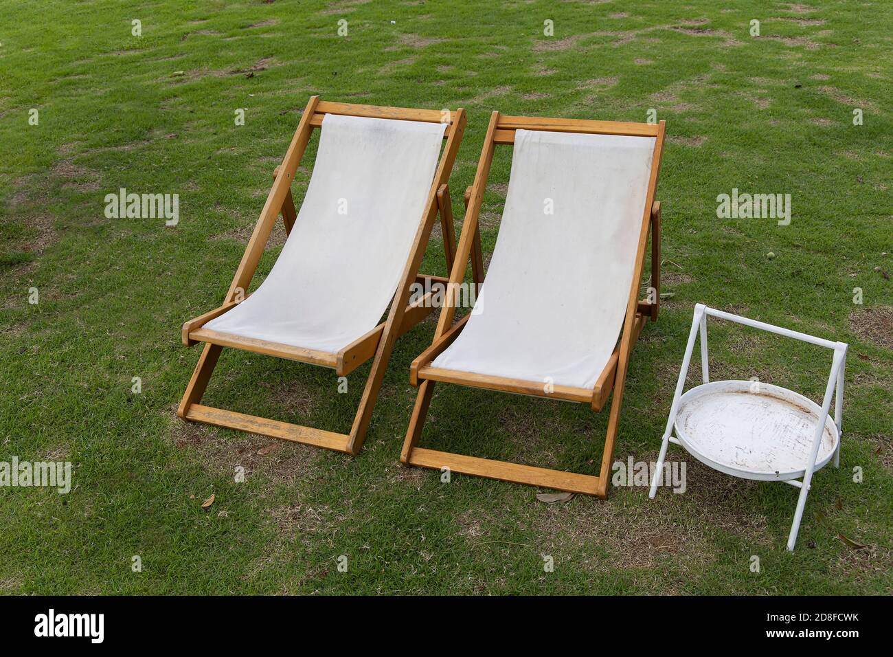 White deck chairs on the lawn in the garden Stock Photo Alamy