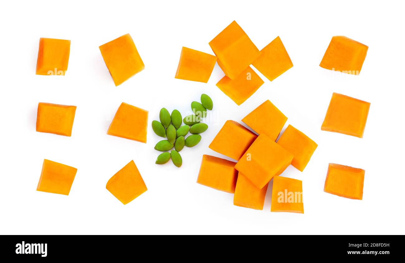 Creative layout made of Pumpkin pieces cut in a cube slices isolated on white background. Pumpkin Pattern Stock Photo