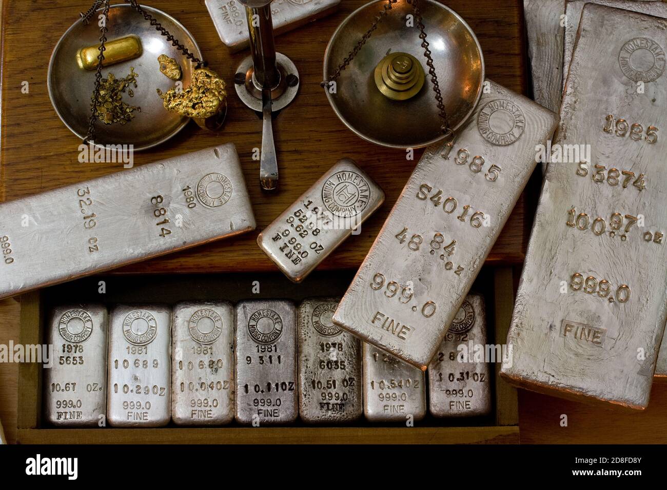 Homestake Mining Company silver bullion bars. Now closed mine located at Lead, South Dakota - Black Hills, USA. Gold bar and nuggets on balance scale. Stock Photo