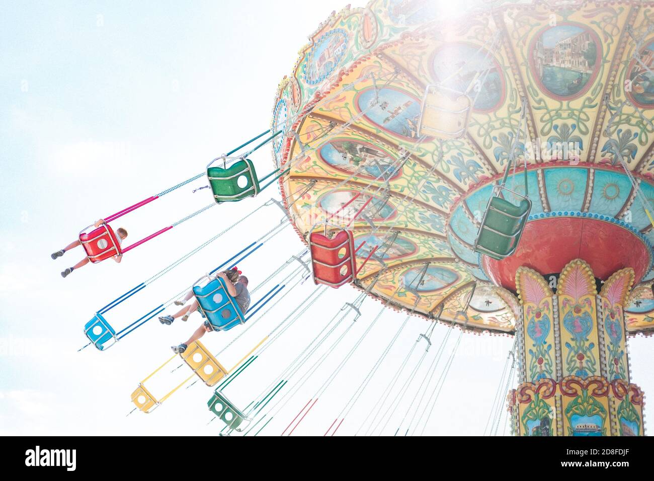 dad and daughter on a swing ride at a carnival Stock Photo